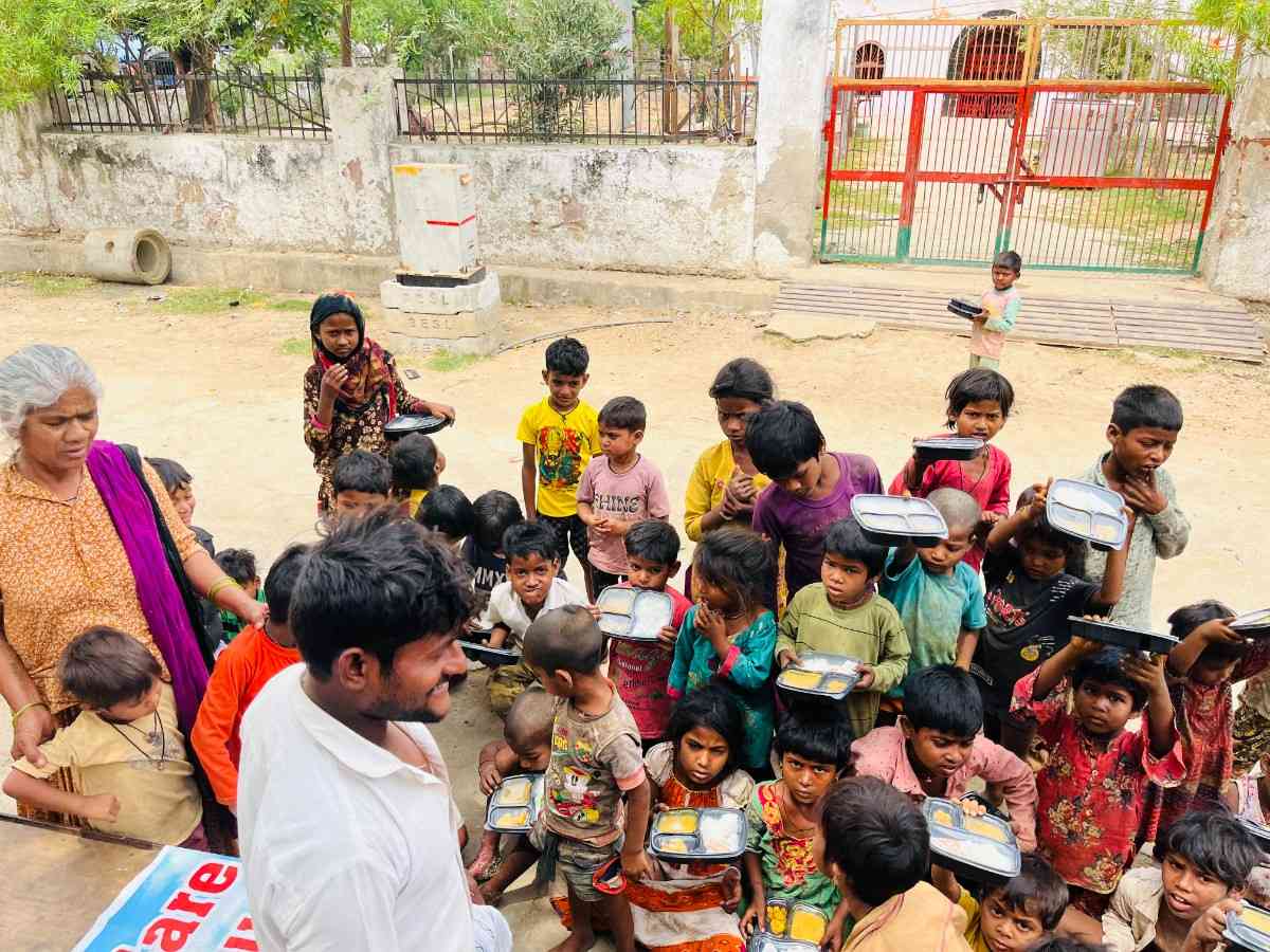 Children receiving a hot meal from Child Care India Trust