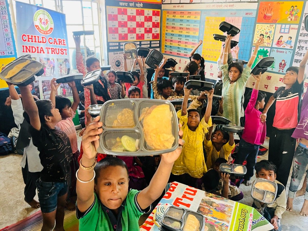 Children smiling during a Child Care India Trust food drive